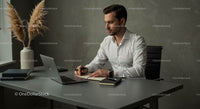 Focused Businessman Working at Modern Office Desk