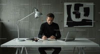Focused Man Working at Minimalist Desk in Modern Office