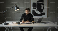 Man Writing Notes in Modern Minimalist Office Setting