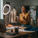 Joyful Fashion Designer Laughing in Creative Studio
