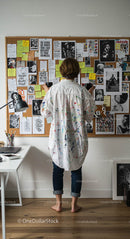 Artist Contemplating Bulletin Board in Creative Studio