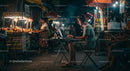 Digital Nomad Working at Night Market with Street Food Stalls