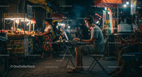 Digital Nomad Working at Night Market with Street Food Stalls