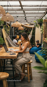 Woman Working on Laptop in Cozy Outdoor Cafe