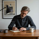 Man in Casual Wear Writing at Wooden Desk