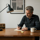 Man Writing at Desk in Stylish Minimalist Workspace
