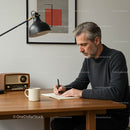 Man Writing at Desk in Modern Home Office Environment