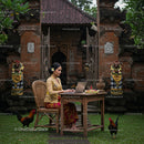 Balinese Woman Working on a Laptop in Traditional Attire