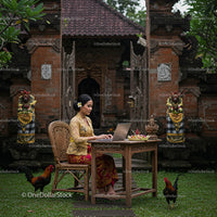 Balinese Woman Working on a Laptop in Traditional Attire
