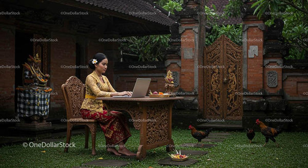 Balinese Woman Working on Laptop in Traditional Garden