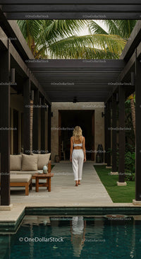 Woman Walking in Tropical Villa with Palm Trees and Pool