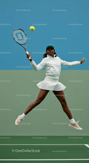 Female Tennis Player In Mid-Action on Green Court