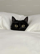 Adorable Black Cat Nestled in White Bedding