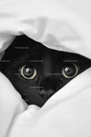 Curious Black Cat Peeking from Underneath Blanket