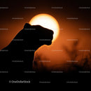 Lion Silhouette Against Vibrant Sunset Horizon