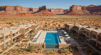 Desert Resort with Pool and Sandstone Cliffs in Background