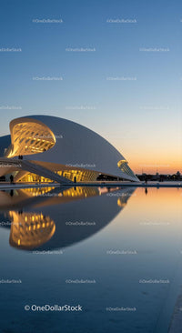 Futuristic Architecture at Sunset with Water Reflection
