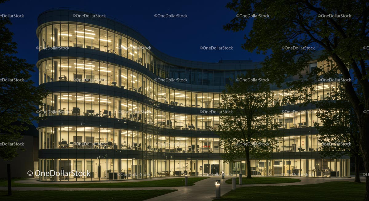 Modern Office Building with Curved Glass Facade at Night