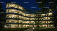 Modern Office Building with Curved Glass Facade at Night