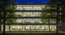 Modern Office Building at Night with Illuminated Windows