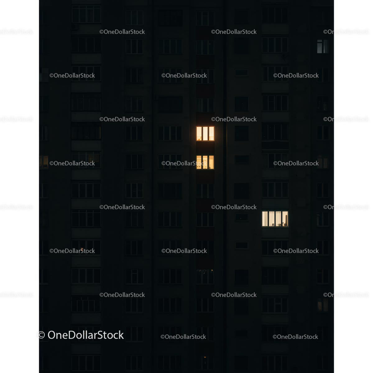 City Apartment Building with Illuminated Windows at Night