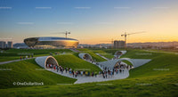 Futuristic Building and People in Modern Urban Park at Sunset