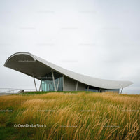 Modern Architecture with Curved Roof and Lush Landscape