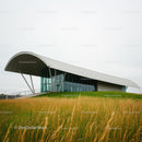 Futuristic Building Design with Curved Roof in Green Landscape