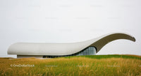 Modern Building with Curved Roof in Open Landscape