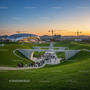 Sunset Over Modern Architecture and Lush Green Hills