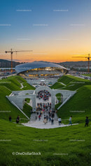Modern Architectural Marvel at Sunset with Crowds