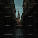 Historic European City Street at Dusk with Tower View
