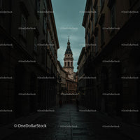 Historic European City Street at Dusk with Tower View