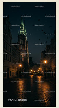 Illuminated Church Tower on Cobblestone Street at Night