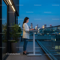 Businesswoman Working on Rooftop with Stunning Cityscape