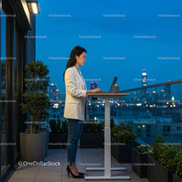 Professional Woman Working at a Standing Desk on Rooftop