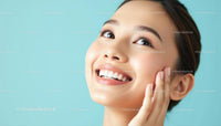 Smiling Woman with Radiant Skin on Light Blue Background
