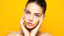 Portrait of a Young Woman Against Vibrant Yellow Background