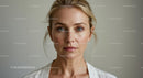 Serious Woman with Blonde Hair and Green Eyes in Close-Up Portrait
