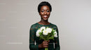 Smiling Woman in Green Dress Holding White Flower Bouquet