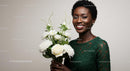 Smiling Woman Holding White Rose Bouquet in Green Dress