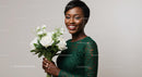Smiling Woman Holding White Bouquet in Green Lace Dress
