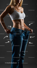 Fit Woman in Oversized Jeans Demonstrating Weight Loss Success