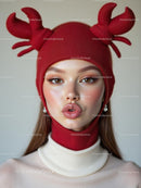 Stylish Woman in Red Crab Hat with Bold Makeup