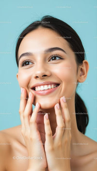 Young Woman Smiling with Radiant Skin Against Blue Background