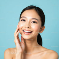 Smiling Woman with Glowing Skin on Blue Background