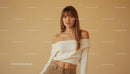 Stylish Woman in Off-Shoulder Sweater Against Beige Background