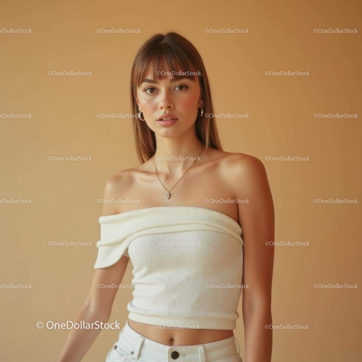 Young Woman in Off-Shoulder Top Posing Against Warm Background