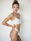 Confident Woman in White Swimsuit Posing
