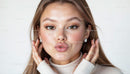 Elegant Woman in Stylish Earrings Blowing a Kiss